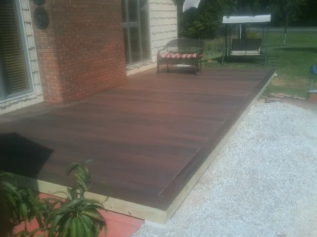 Freshly stained wood deck built against a brick home in Williamsfield